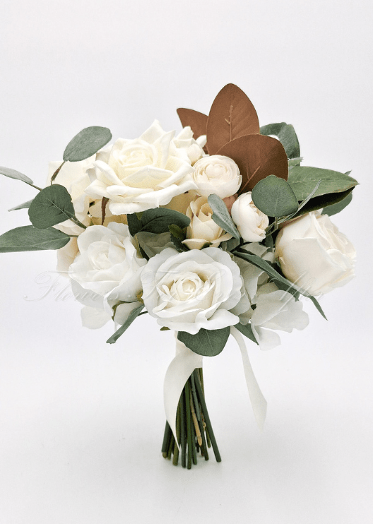 Artificial wedding bridesmaid bouquet with ivory faux roses, pale ranunculus, white blooms, eucalyptus and brown magnolia leaves. Made in Melbourne by Flowers For Ever After, shipping Australia and Worldwide.