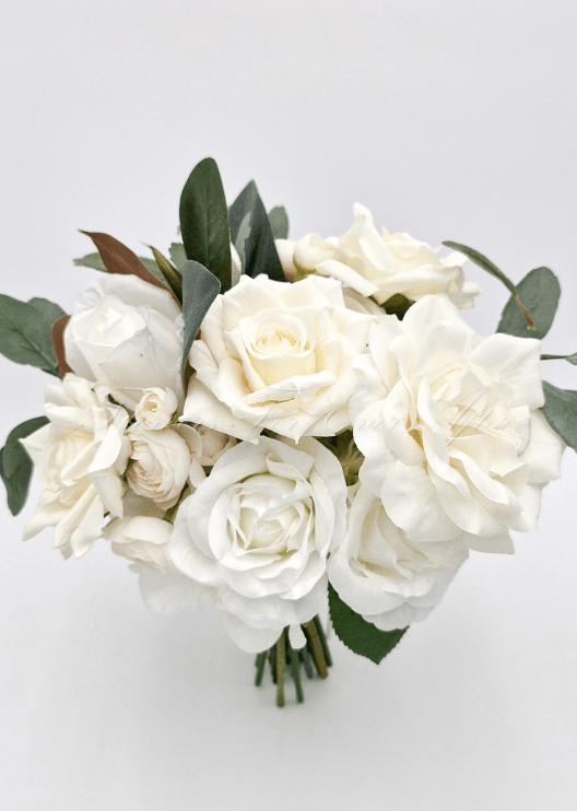 Artificial wedding bridesmaid bouquet, top view of ivory faux roses, pale blooms, eucalyptus and brown magnolia leaves. Made in Melbourne by Flowers For Ever After, shipping Australia and Worldwide.
