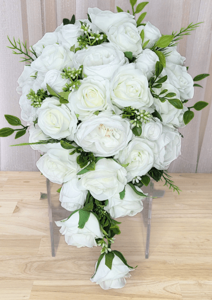 Artificial wedding cascading bouquet with white faux roses and peonies, tiny white buds, green leaves and trailing white rosebuds. Made in Melbourne by Flowers For Ever After, shipping Australia and Worldwide.