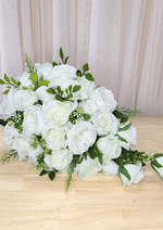 Artificial wedding cascading bouquet, angled view of white faux roses and peonies, green leaves and trailing rosebuds. Made in Melbourne by Flowers For Ever After, shipping Australia and Worldwide.