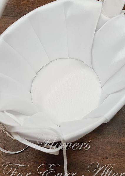 Artificial wedding flower and faux petal basket, overhead view of an empty white fabric-lined interior and ribbon-wrapped handle. Made in Melbourne by Flowers For Ever After, shipping Australia and Worldwide.