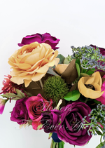 Artificial wedding bridesmaid bouquet close-up with burgundy and pink faux roses, a yellow bloom, green thistle and grey-green sprigs. Made in Melbourne by Flowers For Ever After, shipping Australia and Worldwide.