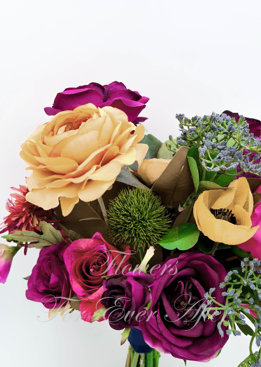 Artificial wedding bridesmaid bouquet close-up with burgundy and pink faux roses, a yellow bloom, green thistle and grey-green sprigs. Made in Melbourne by Flowers For Ever After, shipping Australia and Worldwide.