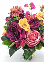 Artificial wedding bridal bouquet close-up with burgundy and dusty pink faux roses, yellow blooms and coral flowers. Made in Melbourne by Flowers For Ever After, shipping Australia and Worldwide.
