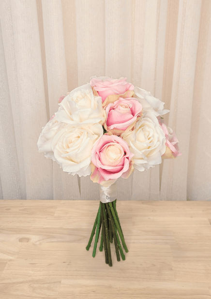 Artificial wedding bridesmaid bouquet with pink and ivory faux roses, ivory ribbon wrapping and green stems. Made in Melbourne by Flowers For Ever After, shipping Australia and Worldwide.