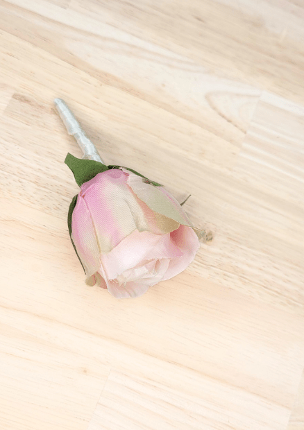 Artificial wedding boutonniere, angled view of pink-and-ivory faux rosebud petals and ivory-wrapped stem. For formals, proms and ball occasions. Made in Melbourne by Flowers For Ever After, shipping Australia and Worldwide.