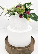 Artificial wedding cake decoration, angled view of green faux protea and native-style foliage. For birthday, event and celebration cakes. Made in Melbourne by Flowers For Ever After, shipping Australia and Worldwide.
