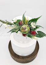 Artificial wedding cake decoration close-up with green faux protea, small blooms and green leaves. For birthday, event and celebration cakes. Made in Melbourne by Flowers For Ever After, shipping Australia and Worldwide.
