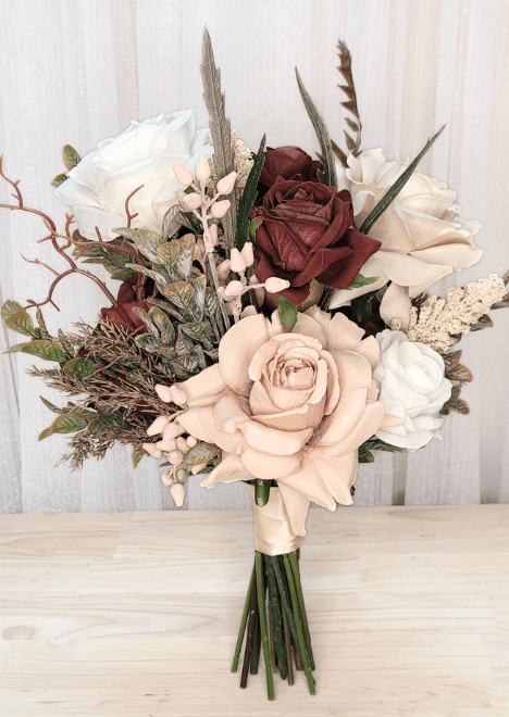 Artificial wedding bridesmaid bouquet with terracotta, beige and ivory faux roses, pale sprigs and narrow textured foliage. Made in Melbourne by Flowers For Ever After, shipping Australia and Worldwide.