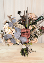 Artificial wedding bouquet, reverse view of terracotta and beige faux roses, grey eucalyptus, pale fan leaf and dark sprigs. Made in Melbourne by Flowers For Ever After, shipping Australia and Worldwide.