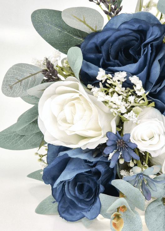 Artificial wedding bouquet close-up with navy and white faux roses, small blue blossoms, tiny white flowers and eucalyptus. Made in Melbourne by Flowers For Ever After, shipping Australia and Worldwide.