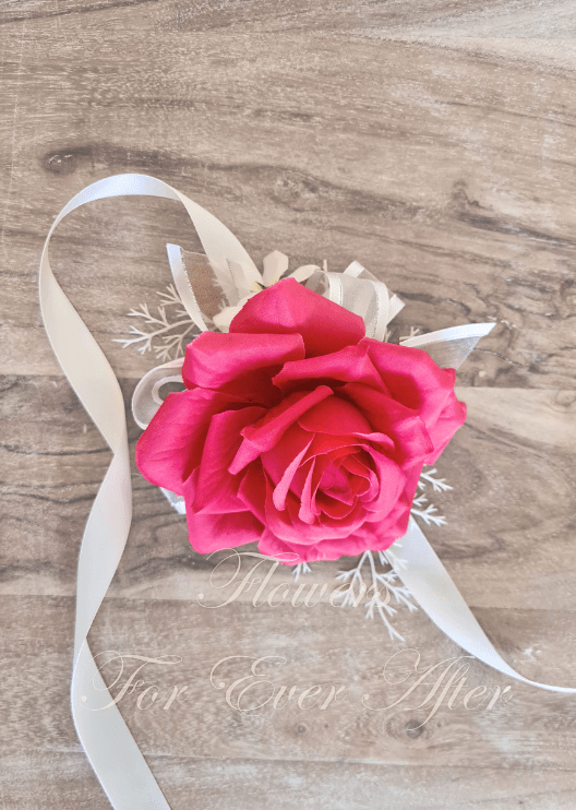 Artificial wedding wrist corsage, side view of hot pink faux roses, pale flowers and green foliage. For formals, proms and ball occasions. Made in Melbourne by Flowers For Ever After, shipping Australia and Worldwide.