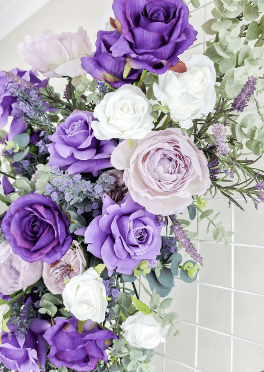 Artificial wedding ceremony floral arrangement, angled view of purple faux flowers and trailing greenery. Made in Melbourne by Flowers For Ever After, shipping Australia and Worldwide.