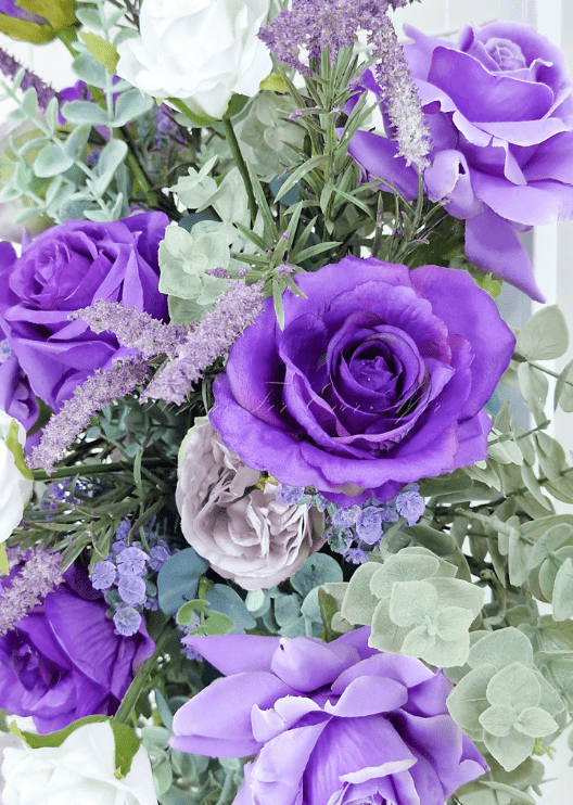 Artificial wedding ceremony flower arrangement, side view of purple faux flowers and trailing green foliage. Made in Melbourne by Flowers For Ever After, shipping Australia and Worldwide.