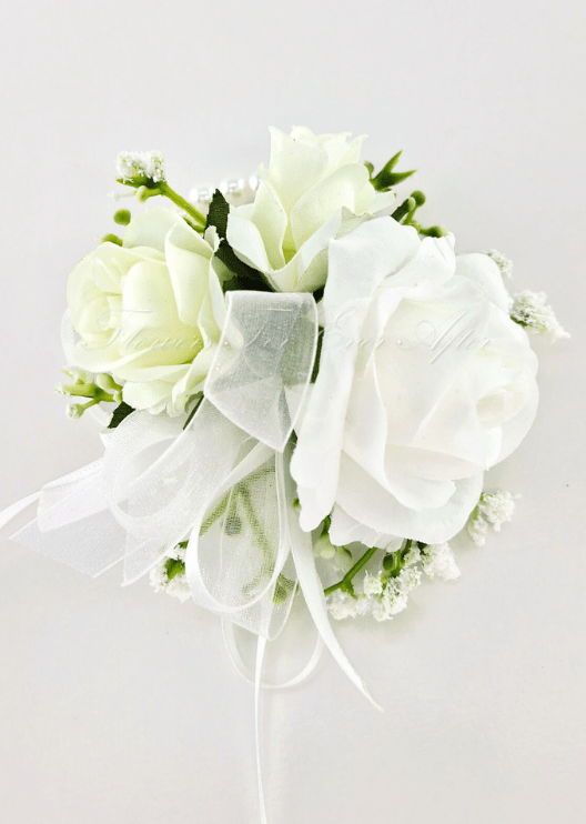 Artificial wedding wrist corsage with white faux roses, tiny white flowers and trailing sheer white ribbons. For formals, proms and ball occasions. Made in Melbourne by Flowers For Ever After, shipping Australia and Worldwide.