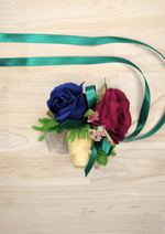Artificial wedding wrist corsage, overhead view of navy, magenta and cream faux roses, pink blossoms and green ribbons. For formals, proms and ball occasions. Made in Melbourne by Flowers For Ever After, shipping Australia and Worldwide.