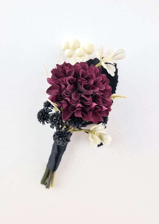 Artificial wedding boutonniere with a burgundy faux chrysanthemum, black filler flowers, cream blooms and black-wrapped stems. For formals, proms and ball occasions. Made in Melbourne by Flowers For Ever After, shipping Australia and Worldwide.