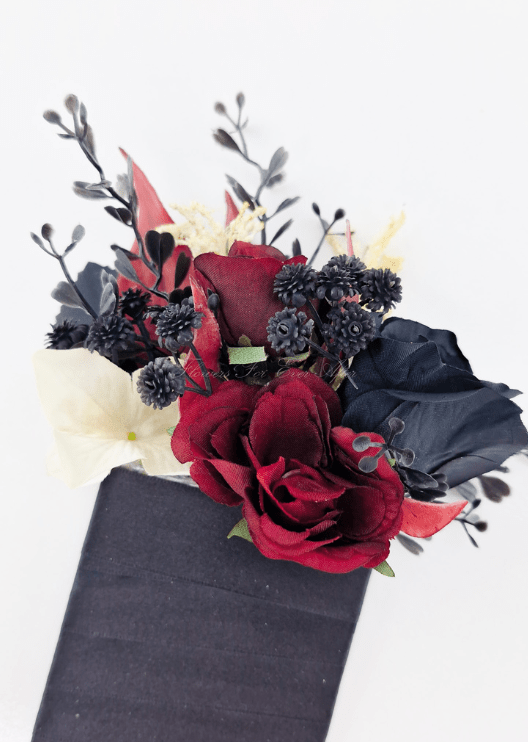Artificial wedding pocket corsage close-up with burgundy and black faux roses, black berry clusters and dark sprigs. For formals, proms and ball occasions. Made in Melbourne by Flowers For Ever After, shipping Australia and Worldwide.