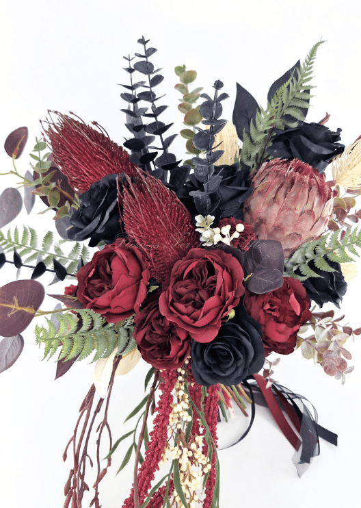 Artificial wedding bridal bouquet close-up with burgundy and black faux roses, pink protea, burgundy spiky blooms and eucalyptus. Made in Melbourne by Flowers For Ever After, shipping Australia and Worldwide.