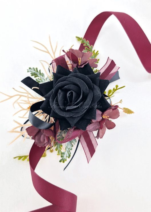 Artificial wedding wrist corsage, angled view of a black faux rose, burgundy flowers, pale sprigs and black and burgundy ribbons. For formals, proms and ball occasions. Made in Melbourne by Flowers For Ever After, shipping Australia and Worldwide.