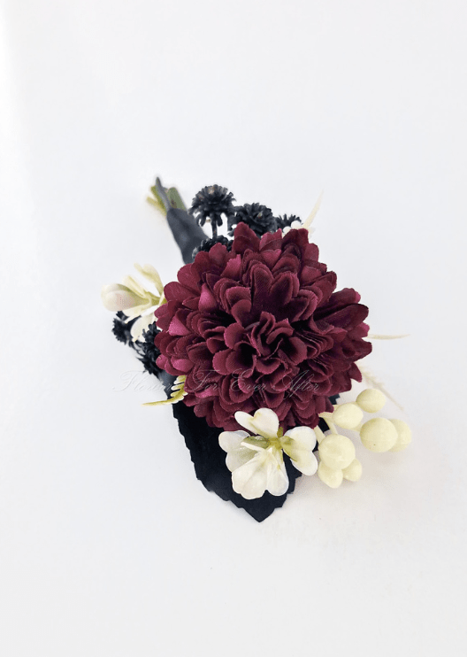 Artificial wedding boutonniere, top view of a burgundy faux chrysanthemum, cream blooms and black filler flowers. For formals, proms and ball occasions. Made in Melbourne by Flowers For Ever After, shipping Australia and Worldwide.