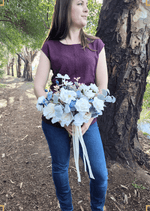 Artificial wedding bridal bouquet held in both hands, with mixed faux flowers, green leaves and trailing ribbon. Made in Melbourne by Flowers For Ever After, shipping Australia and Worldwide.