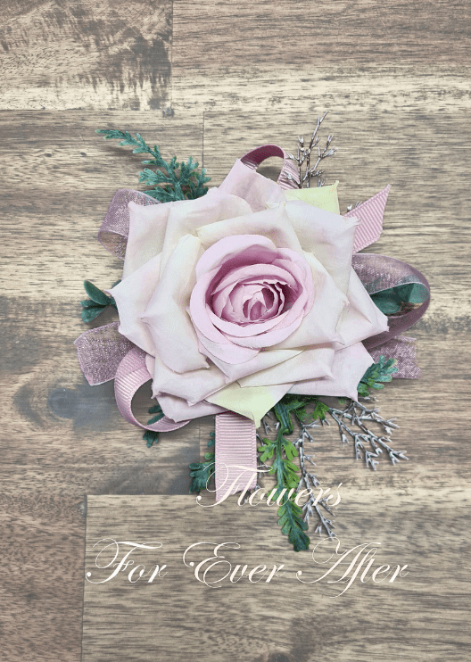 Artificial wedding corsage close-up with a pale lavender faux rose, white filler flowers and trailing ivory ribbons. For formals, proms and ball occasions. Made in Melbourne by Flowers For Ever After, shipping Australia and Worldwide.