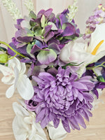 A mixed artificial floral bouquet with purple and white flowers, including a large purple chrysanthemum, white orchids, white calla lilies, and purple delphiniums.  Made in Melbourne Australia, by Australia's best silk bridal florist