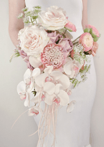 Artificial wedding cascading bridal bouquet with white faux orchids, small flowers and trailing green foliage. Made in Melbourne by Flowers For Ever After, shipping Australia and Worldwide.