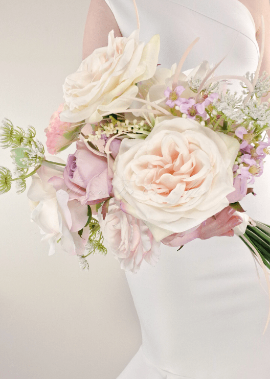 Artificial wedding bridesmaid bouquet with white faux orchids, green leaves and ribbon-wrapped stems. Made in Melbourne by Flowers For Ever After, shipping Australia and Worldwide.