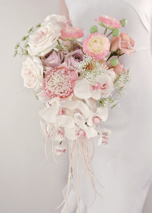 Artificial wedding cascading bridal bouquet close-up showing white faux orchid petals and green foliage. Made in Melbourne by Flowers For Ever After, shipping Australia and Worldwide.