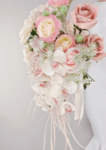 Artificial wedding bridal bouquet, angled view of white faux orchids and trailing greenery. Made in Melbourne by Flowers For Ever After, shipping Australia and Worldwide.