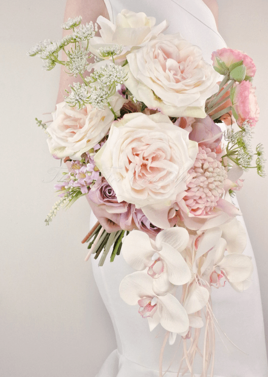 Artificial wedding cascading bridal bouquet, side view of white faux orchids, smaller flowers and green leaves. Made in Melbourne by Flowers For Ever After, shipping Australia and Worldwide.