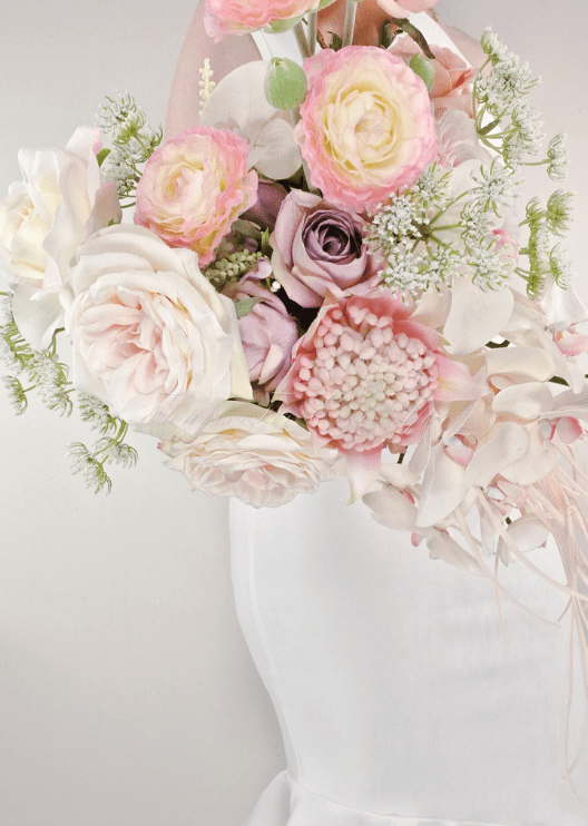 Artificial wedding bridal bouquet close-up showing white faux orchids, small flowers and foliage. Made in Melbourne by Flowers For Ever After, shipping Australia and Worldwide.