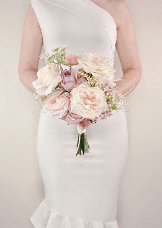 Artificial wedding bridesmaid bouquet, front view of white faux orchids, small blooms and green leaves. Made in Melbourne by Flowers For Ever After, shipping Australia and Worldwide.