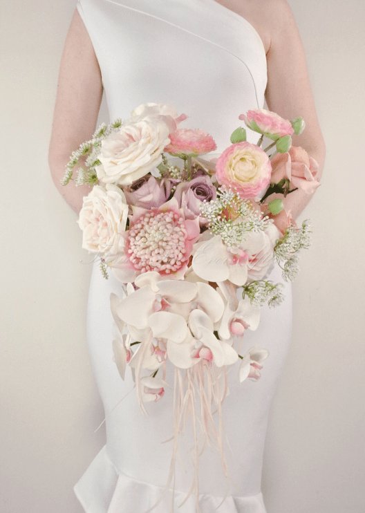 Artificial wedding bridal bouquet, front view of white faux orchids, small flowers and cascading greenery. Made in Melbourne by Flowers For Ever After, shipping Australia and Worldwide.