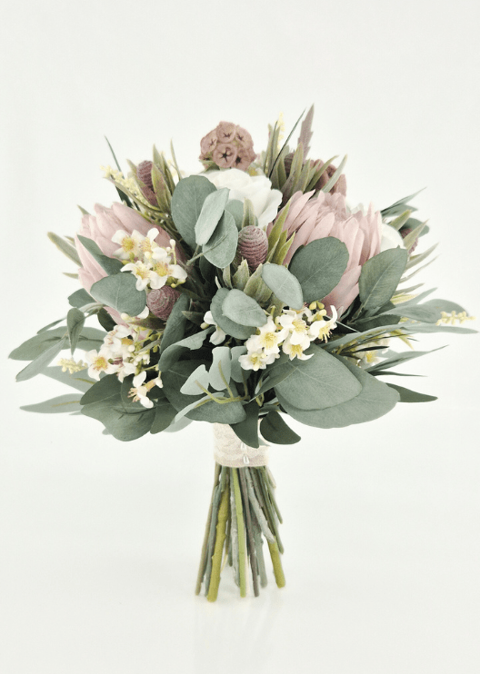 Artificial wedding bouquet, reverse view of ivory faux roses, pink proteas, tan lotus pods, cream flower sprigs and rounded eucalyptus. Made in Melbourne by Flowers For Ever After, shipping Australia and Worldwide.