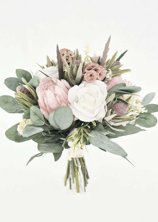 Artificial wedding bridal bouquet with ivory faux roses, blush pink proteas, tan lotus pods, grey seedpods and broad eucalyptus foliage. Made in Melbourne by Flowers For Ever After, shipping Australia and Worldwide.