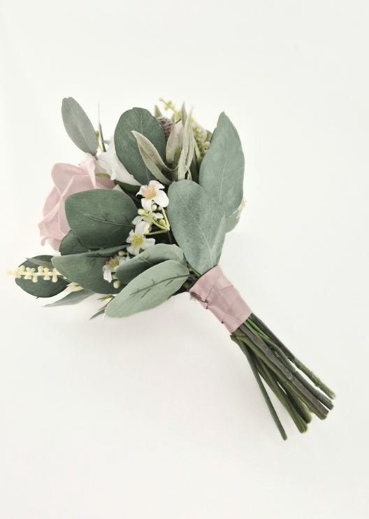 Artificial wedding small bouquet, reverse side view showing faux eucalyptus, pale narrow leaves, cream flower sprigs and blush-wrapped stems. Made in Melbourne by Flowers For Ever After, shipping Australia and Worldwide.