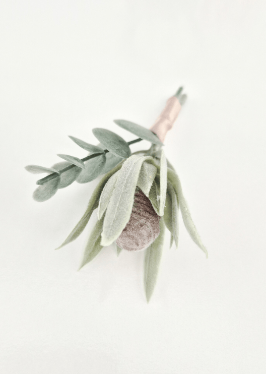 Artificial wedding boutonniere, overhead view of a grey faux seedpod, pale narrow leaves and rounded eucalyptus. For formals, proms and ball occasions. Made in Melbourne by Flowers For Ever After, shipping Australia and Worldwide.