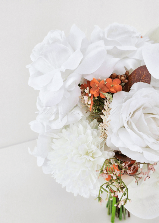 Artificial wedding bouquet close-up with white faux roses, orchids, orange flowers, brown berries and brown leaves. Made in Melbourne by Flowers For Ever After, shipping Australia and Worldwide.