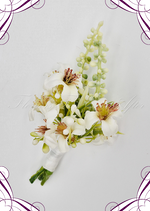 Artificial wedding boutonniere close-up with a white faux rose, small flowers and green foliage. For formals, proms and ball occasions. Made in Melbourne by Flowers For Ever After, shipping Australia and Worldwide.