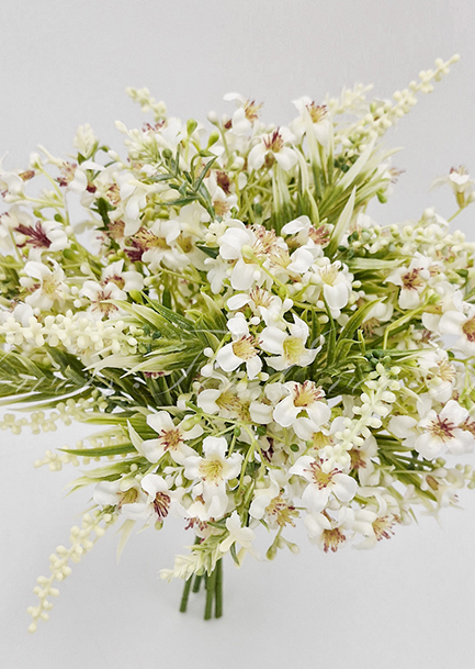 Artificial wedding bridesmaid bouquet, angled view of white faux roses, rounded white blooms and green foliage. Made in Melbourne by Flowers For Ever After, shipping Australia and Worldwide.