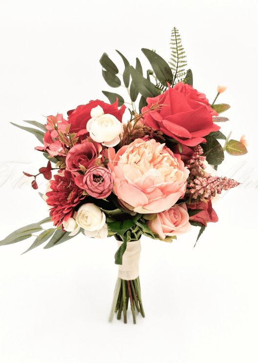 Artificial wedding bridesmaid bouquet with red and coral faux roses, a cream-and-coral peony, ivory blooms, red daisies and eucalyptus. Made in Melbourne by Flowers For Ever After, shipping Australia and Worldwide.