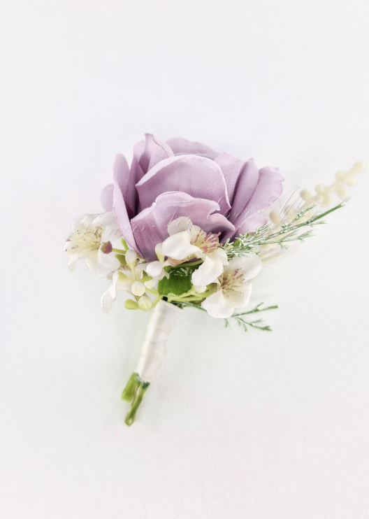 Artificial wedding boutonniere with a mauve faux rose, tiny ivory flowers, fine green sprigs and ivory-wrapped stems. For formals, proms and ball occasions. Made in Melbourne by Flowers For Ever After, shipping Australia and Worldwide.