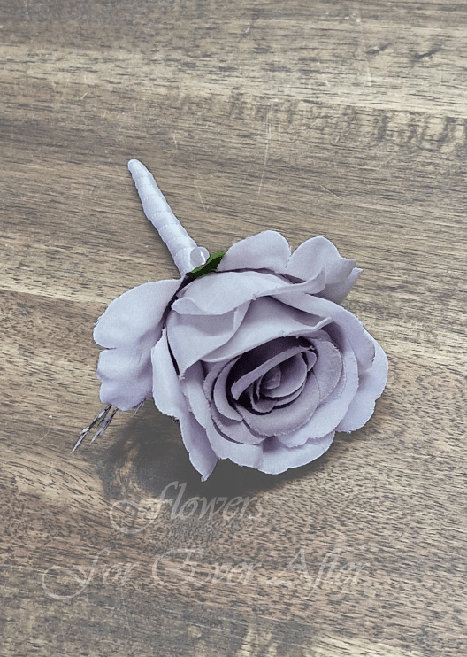 Artificial wedding boutonniere, top view of a mauve faux rose and dark filler sprigs. For formals, proms and ball occasions. Made in Melbourne by Flowers For Ever After, shipping Australia and Worldwide.