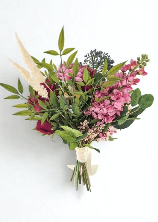 Artificial wedding bouquet, reverse view of pink faux flower spikes, burgundy blooms, blue-grey berries, green leaves and pale plumes. Made in Melbourne by Flowers For Ever After, shipping Australia and Worldwide.
