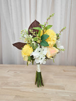 A bright and boldly unique silk flower bridesmaid bouquet. Realistic yellow, whit and burgundy faux florals in an affordable design perfect for a small wedding or elopement or registry wedding.  Made in Melbourne Australia, by Australia's best bridal florist