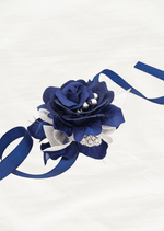 Artificial wedding wrist corsage, angled view of a navy blue faux rose with silver accents and long navy ribbon ties. For formals, proms and ball occasions. Made in Melbourne by Flowers For Ever After, shipping Australia and Worldwide.