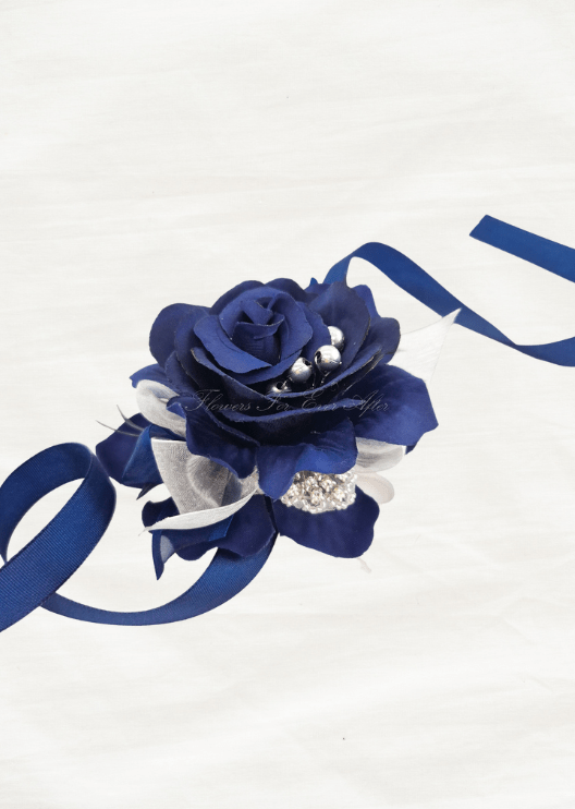 Artificial wedding wrist corsage, angled view of a navy blue faux rose with silver accents and long navy ribbon ties. For formals, proms and ball occasions. Made in Melbourne by Flowers For Ever After, shipping Australia and Worldwide.